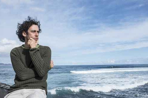 image of man looking at waves after attending our opiate detox center in florida